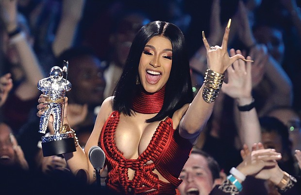 Cardi B delightedly accepts the Best Hip-Hop Video Award for “Money,” beating out a lineup of male competitors.
