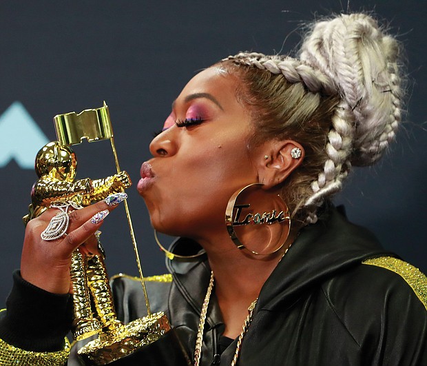 Missy ElliotT shows love for her Michael Jackson Video Vanguard Award for lifetime achievement on Monday backstage at the MTV Video Music Awards at the Prudential Center in Newark, N.J.