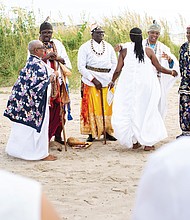 African chiefs lead a sunrise cleansing and African naming ceremony that drew hundreds to Buckroe Beach in Hampton. The solemn event, organized by Roots to Glory, included libations to the ancestors. (photo by Brian Palmer)