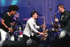 Saxophonists Paul Taylor, Vincent Ingala and Michael Lington of Sax to the Max rock the arena. (photo by Randy Singleton)