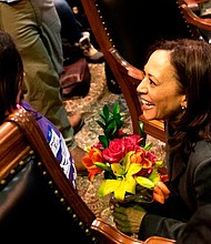 Harris said she is energized by meeting children on the trail, as here in the Iowa statehouse.