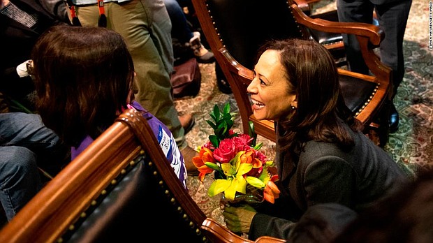 Harris said she is energized by meeting children on the trail, as here in the Iowa statehouse.