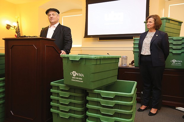 Rabbi Yehuda Pearl, honorary chairman of and early investor in Israel-based UBQ Materials, shows off recycling bins made in part with material UBQ created from household waste. Looking on is Kim Hynes, executive director of Central Virginia Waste Management Authority, the first government agency in the nation to purchase these bins. Location: The State Capitol. The rabbi is founder of Sabra Dipping Co., maker of Sabra hummus.