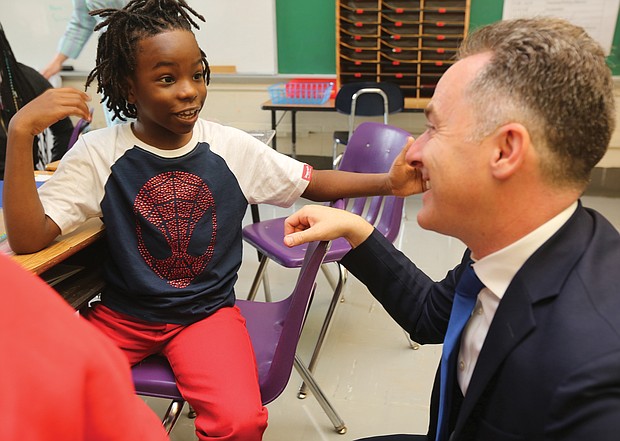 Fifth-grader Akai Dupree Jr., 10, talks with Richmond Public Schools Superintendent Jason Kamras at Westover Hills Elementary School as classes start for the new academic year.