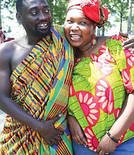 Kojo Marfo wears traditional Kente cloth from the Ashanti region of Ghana as he hugs his wife of 10 years, Anne Odumah Panti. The Richmond couple are natives of Ghana.