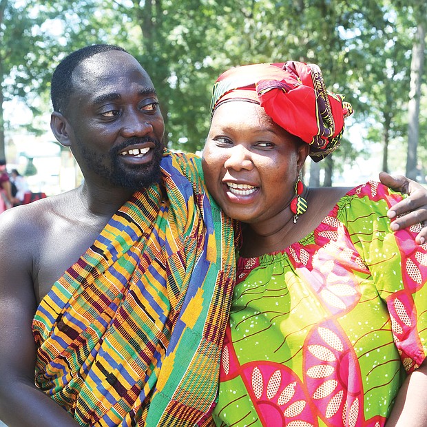 Kojo Marfo wears traditional Kente cloth from the Ashanti region of Ghana as he hugs his wife of 10 years, Anne Odumah Panti. The Richmond couple are natives of Ghana.