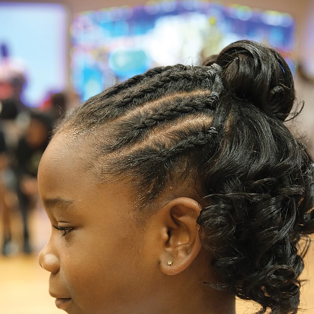 Ella Robinson, 6, shows off her new style for her first day in first grade at Obama Elementary School.