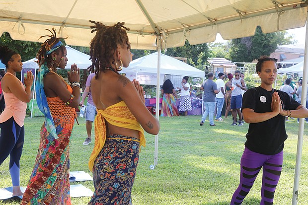 Keeper Sankara leads a yoga flow during the 17th Annual Happily Natural Day last Saturday in South Side. The festival, held at the Fifth District Mini-Farm in the 2200 block of Bainbridge Street, promotes holistic health, cultural awareness and social change.