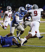 Virginia Union University running back Tabyus Taylor of Hopewell carries the ball past the Hampton University defense during last Saturday’s game at Armstrong Stadium in Hampton. The VUU Panthers beat the Pirates 36-21.