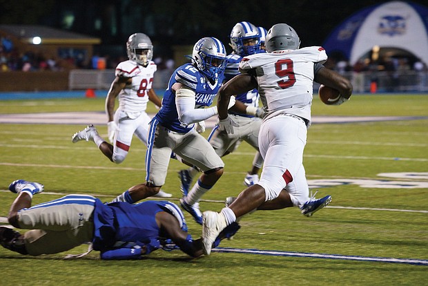 Virginia Union University running back Tabyus Taylor of Hopewell carries the ball past the Hampton University defense during last Saturday’s game at Armstrong Stadium in Hampton. The VUU Panthers beat the Pirates 36-21.