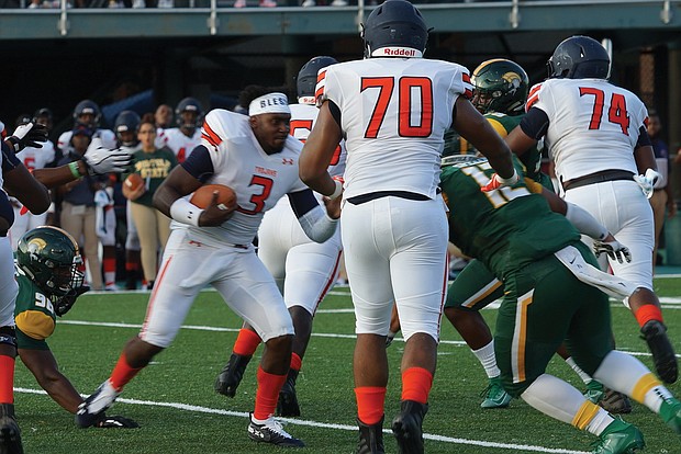 Despite losing his helmet, Virginia State University quarterback Cordelral Cook scrambles to carry the ball during last Saturday’s game against Norfolk State University at Dick Price Stadium in Norfolk.