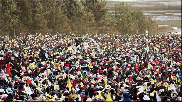 Pope Francis, background center, is cheered by a crowd of faithful last Sunday as he arrives in the popemobile to celebrate Mass in Antananarivo, Madagascar. The pope was in Madagascar for the second leg of his weeklong trip to Africa.