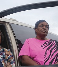 Janice F. Lewis, left, and her sister, Celieto L. Lewis, stand beside their vehicle, which now doubles as their bedroom. The sisters have been homeless since Aug. 23, when the house they were renting was condemned after a kitchen fire.