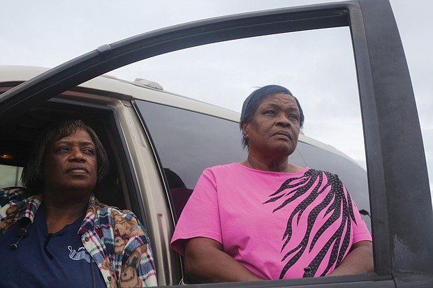 Janice F. Lewis, left, and her sister, Celieto L. Lewis, stand beside their vehicle, which now doubles as their bedroom. The sisters have been homeless since Aug. 23, when the house they were renting was condemned after a kitchen fire.