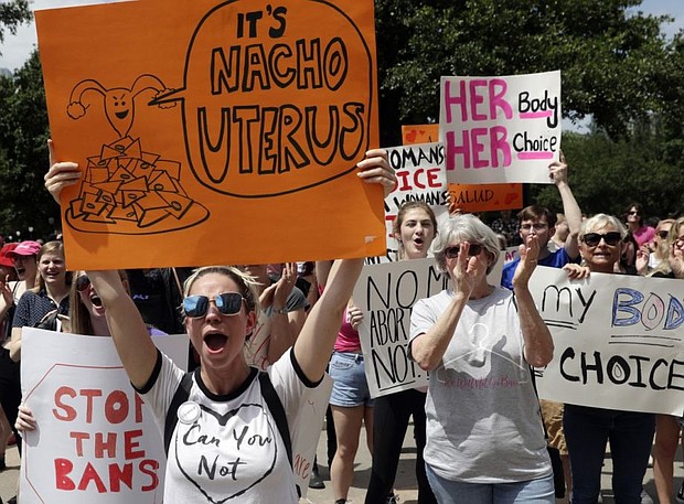 A group gathers to protest abortion restrictions at the State Capitol in Austin, Texas/AP Eric Gay