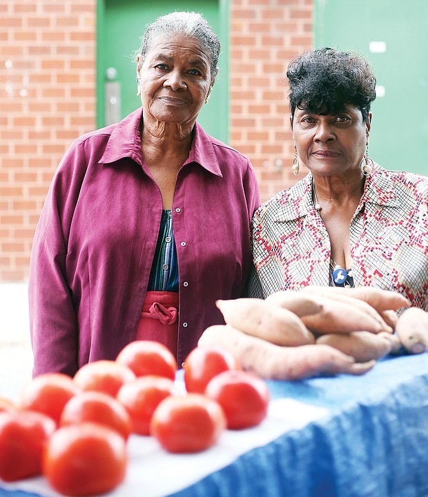 Sisters Evelyn Luceal Allen, left, and Rosa L. Fleming have been coming to the 17th Street Farmers’ Market since they were youngsters. For more than 75 years, they have helped family members sell produce grown on the family farm in Hanover before they took over decades ago.