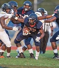 Virginia State University running back Demetrius Strickland rushes the ball down the field during last Saturday’s 35-16 victory over the University of North Carolina at Pembroke during the Trojans’ first home game.