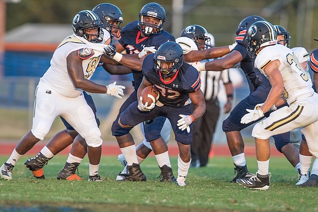 Virginia State University running back Demetrius Strickland rushes the ball down the field during last Saturday’s 35-16 victory over the University of North Carolina at Pembroke during the Trojans’ first home game.