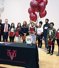 Ninth-graders at Huguenot High School are honored with four-year scholarships to Virginia Union University on Tuesday during a surprise ceremony with officials at the South Side school. Award winners and the officials are, from left, Maurice Campbell, VUU’s senior vice president of corporate and external affairs; Richmond Public Schools Superintendent Jason Kamras; April Leveron; Ashley Duron; Asia Dudley; Huguenot Principal Robert J. Gilstrap; Demarc Oliver; Ingrid Reyes Rodas; Jordan Braxton; Mekhi Reavis; Shayla Saravia; and Mike Newsome, president of the VUU National Alumni Association. Award winner Justin Pair is not pictured.