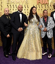 Director Ava DuVernay, center, is joined at Sunday’s Emmy Awards ceremony in Los Angeles by the Exonerated Five, from left, Antron McCray, Raymond Santana, Kevin Richardson, Korey Wise and Yusef Salaam.