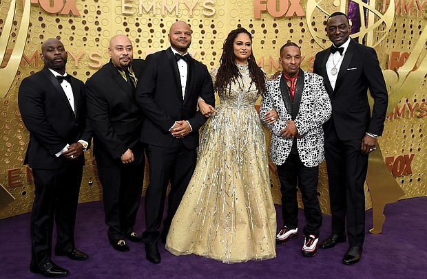 Director Ava DuVernay, center, is joined at Sunday’s Emmy Awards ceremony in Los Angeles by the Exonerated Five, from left, Antron McCray, Raymond Santana, Kevin Richardson, Korey Wise and Yusef Salaam.