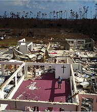 Pastor Jeremiah Saunders stands among the ruins of his church that was destroyed by Hurricane Dorian in High Rock, Grand Bahama, Bahamas, on Sept. 11. The book of Jeremiah reads, “I spoke to the water: ‘Peace, be still.’ It never listened,” Pastor Saunders said with a wide smile and then grew serious as he focused on the task that tens of thousands of Bahamians now face on two islands devastated by the Category 5 storm: The cleanup.