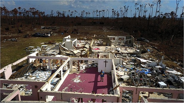 Pastor Jeremiah Saunders stands among the ruins of his church that was destroyed by Hurricane Dorian in High Rock, Grand Bahama, Bahamas, on Sept. 11. The book of Jeremiah reads, “I spoke to the water: ‘Peace, be still.’ It never listened,” Pastor Saunders said with a wide smile and then grew serious as he focused on the task that tens of thousands of Bahamians now face on two islands devastated by the Category 5 storm: The cleanup.