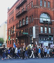 Hundreds of marchers walk along Broad Street in Downtown during an early evening rally and march last Friday from Monroe Park to City Hall as part of the Global Climate Strike.