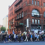 Hundreds of marchers walk along Broad Street in Downtown during an early evening rally and march last Friday from Monroe Park to City Hall as part of the Global Climate Strike.