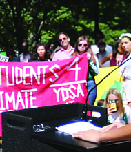 Yasmeen Jaaber, 16, of Chesterfield County and a student at the Appomattox Regional Governor’s School, reads a poem she wrote during the climate change rally last Friday in Capitol Square.