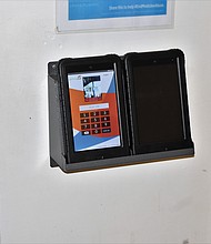 A tablet sits in a docking station in a pod or cellblock at the Richmond Justice Center. Every inmate is assigned a user name and PIN to use the tablets.