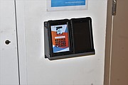 A tablet sits in a docking station in a pod or cellblock at the Richmond Justice Center. Every inmate is assigned a user name and PIN to use the tablets.