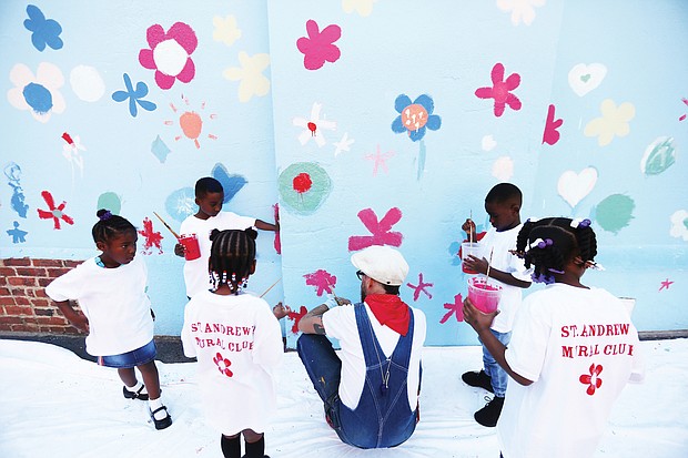 Mr. Milk prepares kindergarten students to participate in the painting last Friday.