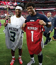 Arizona Cardinals quarterback Kyler Murray, left, and Russell Wilson, quarterback of the Seattle Seahawks, exchange jerseys after last Sunday’s game in Glendale, Ariz.