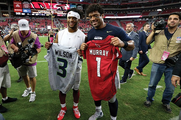 Arizona Cardinals quarterback Kyler Murray, left, and Russell Wilson, quarterback of the Seattle Seahawks, exchange jerseys after last Sunday’s game in Glendale, Ariz.