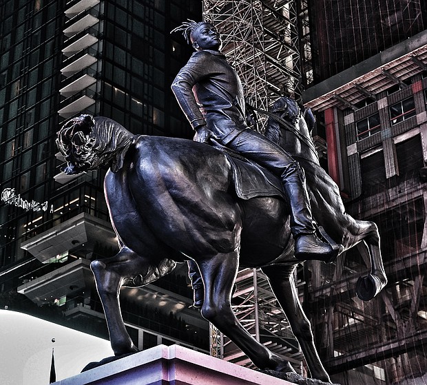 Kehinde Wiley’s statue, “Rumors of War,” is 27 feet tall and took three years from conception to unveiling last Friday in New York’s Times Square. The statue will be moved in December to its permanent home in Richmond outside the Virginia Museum of Fine Arts on Arthur Ashe Boulevard.