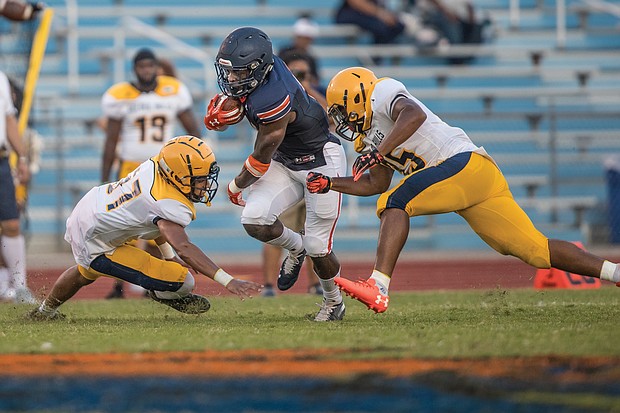 Virginia State University freshman running back Darius Hagans goes in for a 2-yard touchdown during the first quarter of the Trojans’ game against Johnson C. Smith University last Saturday at Rogers Stadium in Ettrick.