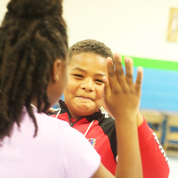 Confidence Building:
Anthony Daniels enjoys his ballroom dancing lessons with his fellow fifth-graders at Southampton Elementary School in South Side. The program is part of Dancing Classrooms Greater Richmond, which uses ballroom dancing as a way to teach students social awareness and build self-esteem among youngsters in fifth and eighth grades. The curriculum, started in Richmond in 2012, is being employed this semester in four Richmond schools and two in Chesterfield. Parents and friends are invited to the final lesson at each school, with students to be selected for a team match Dec. 4 at Huguenot High School. Anthony’s dance partner: Valerie Forrester. (Regina H. Boone/Richmond Free Press)