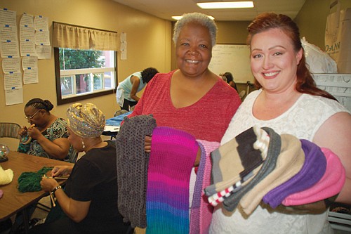 A diverse volunteer sewing group stitches winter warmth for homeless residents A diverse volunteer sewing group stitches winter warmth for homeless residents