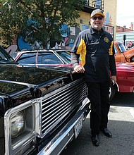 C.T. Woody, former Richmond sheriff, shows off his vintage Chevrolet with the vehicles shown at the festival by the Richmond Metropolitan Antique Car Club. (Sandra Sellars/Richmond Free Press)