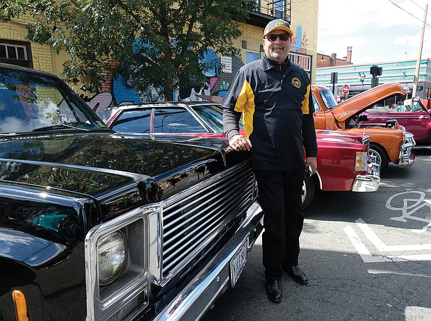 C.T. Woody, former Richmond sheriff, shows off his vintage Chevrolet with the vehicles shown at the festival by the Richmond Metropolitan Antique Car Club. (Sandra Sellars/Richmond Free Press)