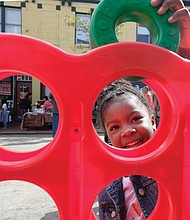 Iyana Reeder, 5, plays a game at the special Kidz Zone last Saturday at the 2nd Street Festival in Richmond’s Historic Jackson Ward. Thousands of people turned out for the free, two-day festival. (Sandra Sellars/Richmond Free Press)