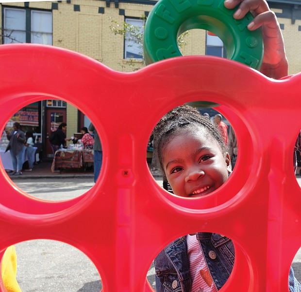 Iyana Reeder, 5, plays a game at the special Kidz Zone last Saturday at the 2nd Street Festival in Richmond’s Historic Jackson Ward. Thousands of people turned out for the free, two-day festival. (Sandra Sellars/Richmond Free Press)