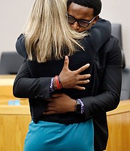 Brandt Jean, 18, hugs Amber Guyger, the former Dallas police officer convicted of murder in the death of his older brother, Botham Jean. The two embraced after he delivered his impact statement during the trial’s sentencing phase.