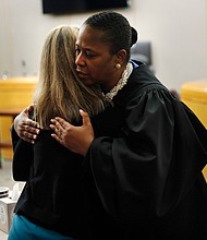 At the trial’s end, Dallas District Judge Tammy Kemp leaves the bench and hugs Ms. Guyger before the former officer is taken away to begin serving a 10-year sentence for Botham Jean’s murder.
