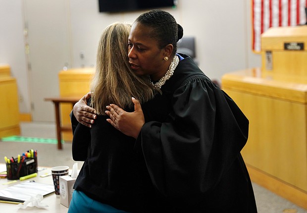 At the trial’s end, Dallas District Judge Tammy Kemp leaves the bench and hugs Ms. Guyger before the former officer is taken away to begin serving a 10-year sentence for Botham Jean’s murder.