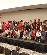 Fifty ninth-graders from Richmond Public Schools pose with officials last Saturday for photographs by happy parents and family members as they are celebrated for receiving four-year academic scholarships to Virginia Union University. The students must keep up their grades and finish high school before enrolling tuition-free at VUU, where their room and board also will be covered by a scholarship currently valued around $108,000. The scholarships are part of the HBCUs “VUU is RVA” campaign to
give greater access to academic, economic, medical and civic support to residents of the Metro Richmond area. Last Saturday’s celebration for the young scholars was held at the Claude G. Perkins Living and Learning Center on VUU’s campus. Officials attending the event included RPS Superintendent Jason Kamras; Dr. Carleitta Paige- Anderson, dean of VUU’s University College; and Richmond School Board members Cheryl L. Burke, 7th District, and Jonathan Young, 4th District. (Ronald E. Carrington/Richmond Free Press)