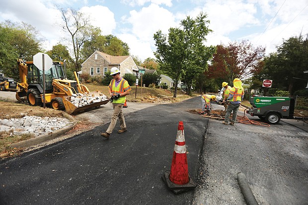 The Fulton neighborhood in the East End is one of the first to get new paving as part of a $15 million program City Hall is undertaking during the current 2019-20 budget year. While one lane on Carlisle Avenue is complete, a city crew on Monday repairs the second lane at the intersection of Carlisle Avenue and Malone Street before repaving.
