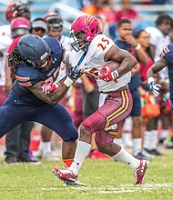 Virginia State University sophomore defensive lineman Javon Frazier takes down Shaw University running back Sidney Gibbs during last Saturday’s game at Rogers Stadium in Ettrick. Shaw’s offense was minimized, with VSU scoring a 35-0 victory.