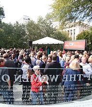 Throngs of people walk around the Virginia Women’s Monument in Capitol Square following Monday’s dedication ceremony. In addition to the bronze statues, the monument has a curved glass Wall of Honor etched with the names of 230 outstanding Virginia women who made contributions to the state and nation during the last 400 years.